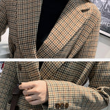 Houndstooth blazer lapel, pocket and belt details